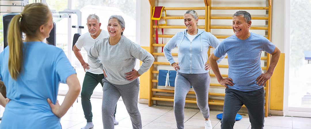 A group of elderly people exercising