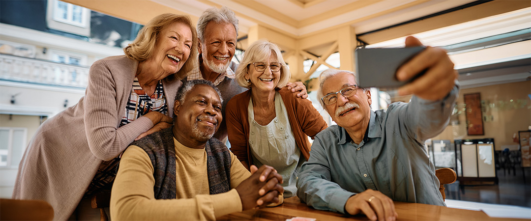Seniors smiling for a photo together.